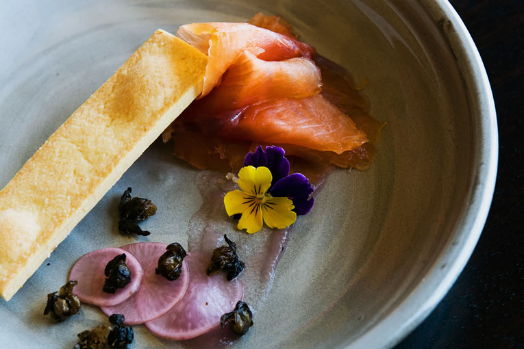 House cured tasmanian salmon with lemon wafers, fried capers, red onion gels and pickled radish