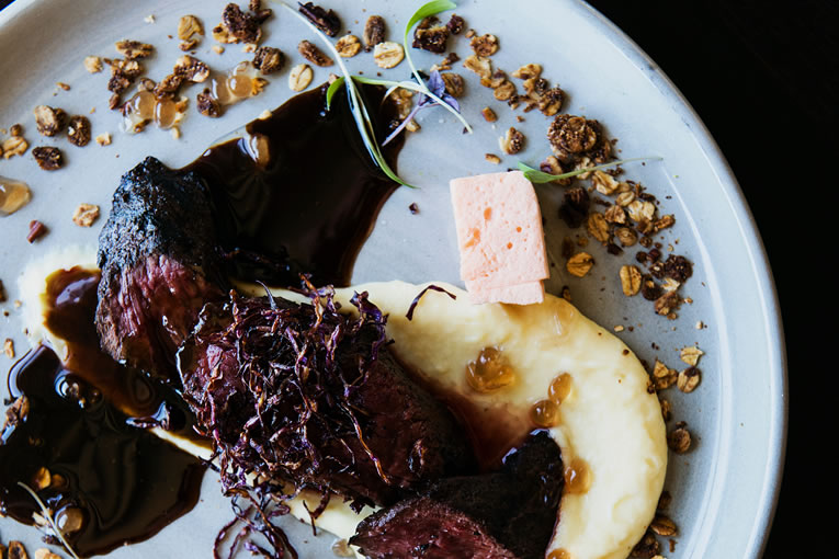 Kangaroo fillet black current pearls with pecan granola, parsnip puree, sweet potato marshmallow and pepper leaf jus